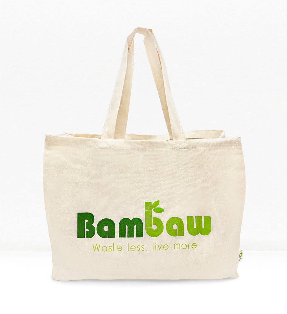 A beige cotton tote bag with the Bambaw brand logo printed in green. The bag has long handles and is displayed against a white background.