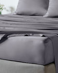 bambaw cozy bamboo bed sheets close up on a bed with fitted sheets and pillows in grey colour