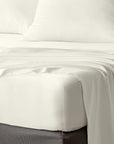 bambaw cozy bamboo bed sheets close up on a bed with fitted sheets and pillows in ivory colour