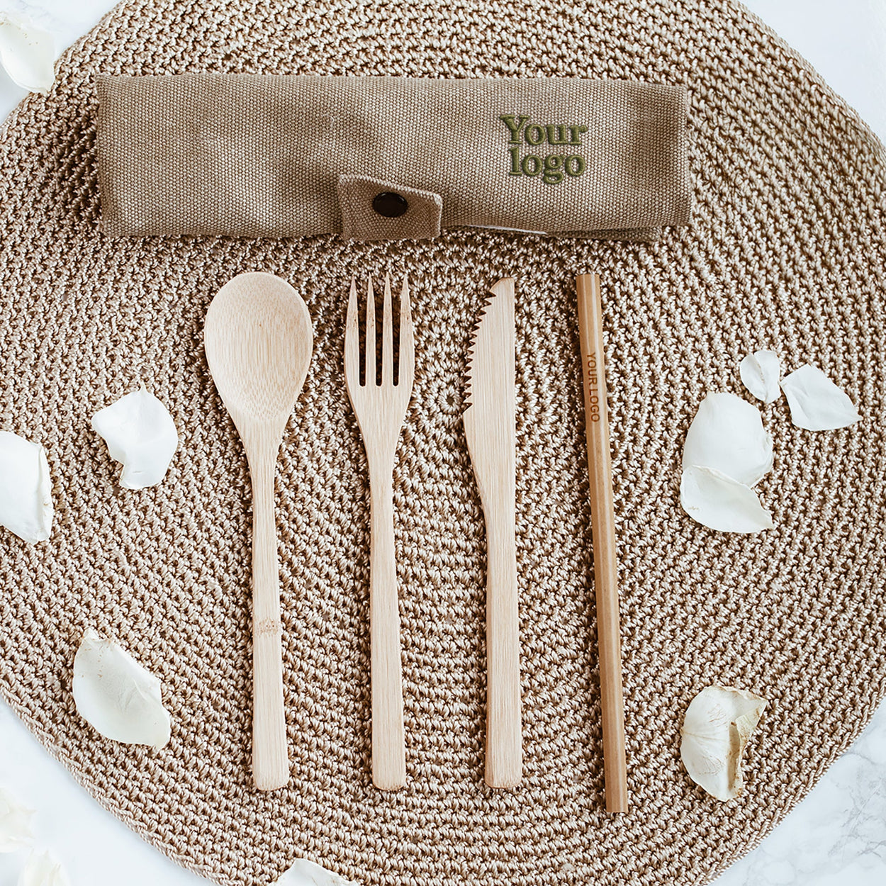 Wooden cutlery set with a napkin holder on a textured surface