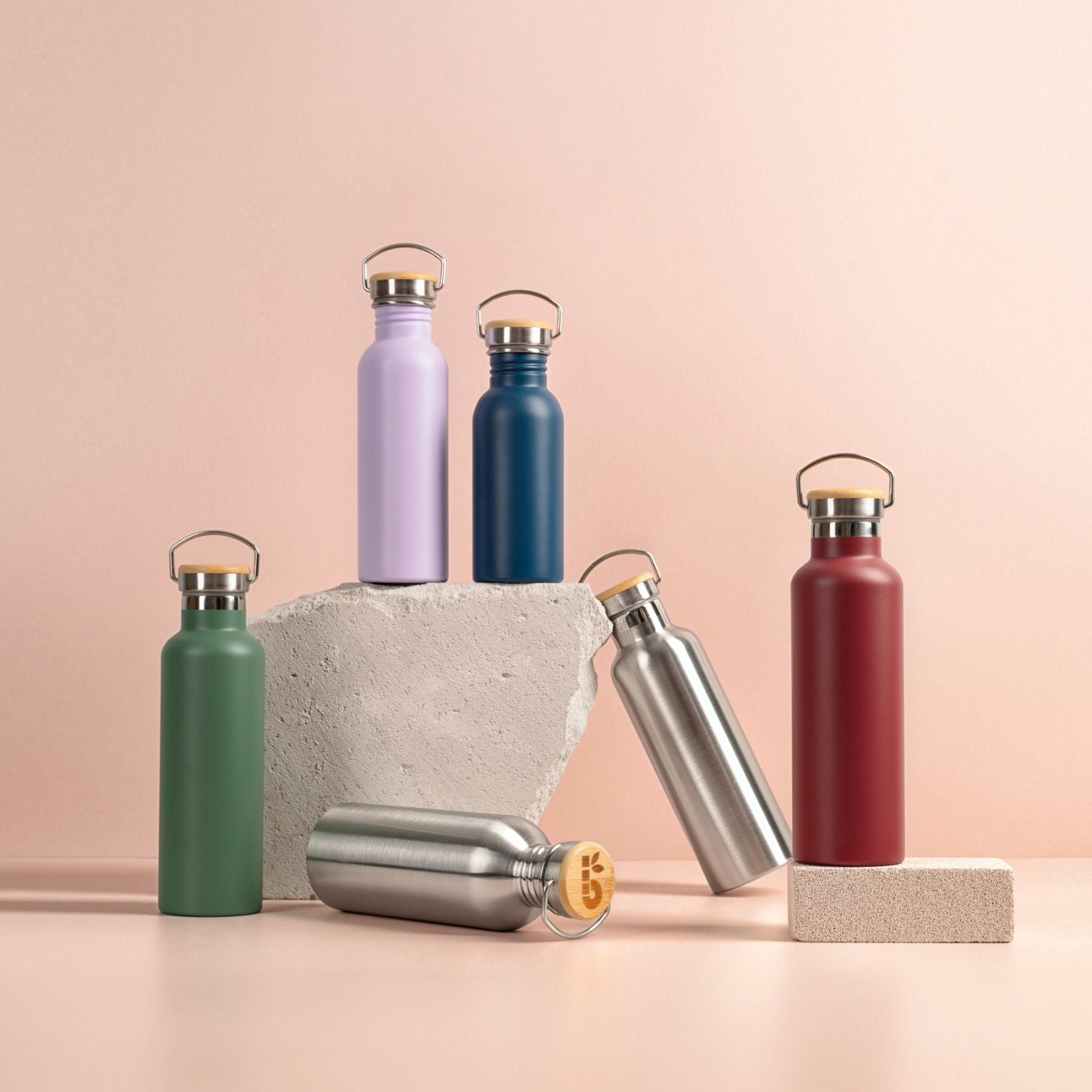 Set of colourful Bambaw stainles steel water bottles on a peach background